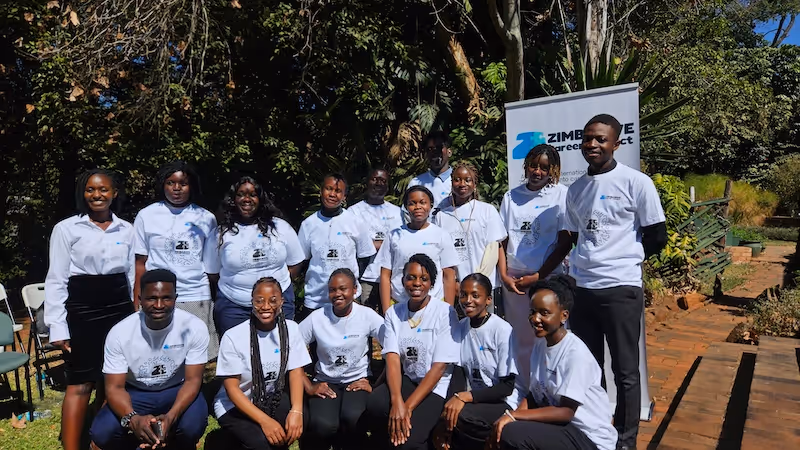 Zimbabwe Education Matters school team in Zimbabwe Africa posing in matching white t-shirts.