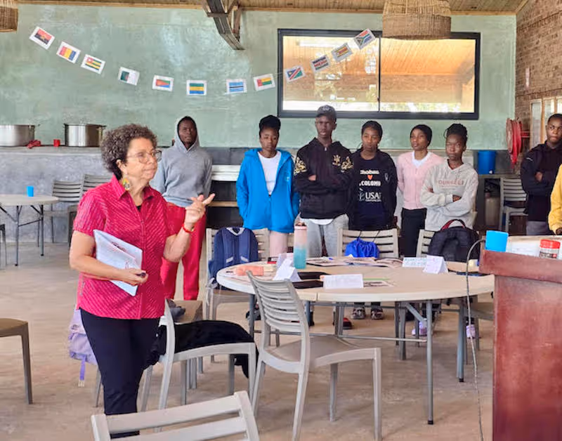 Female educator leads enthusiastic students in Zimbabwe classroom at Education Matters school.
