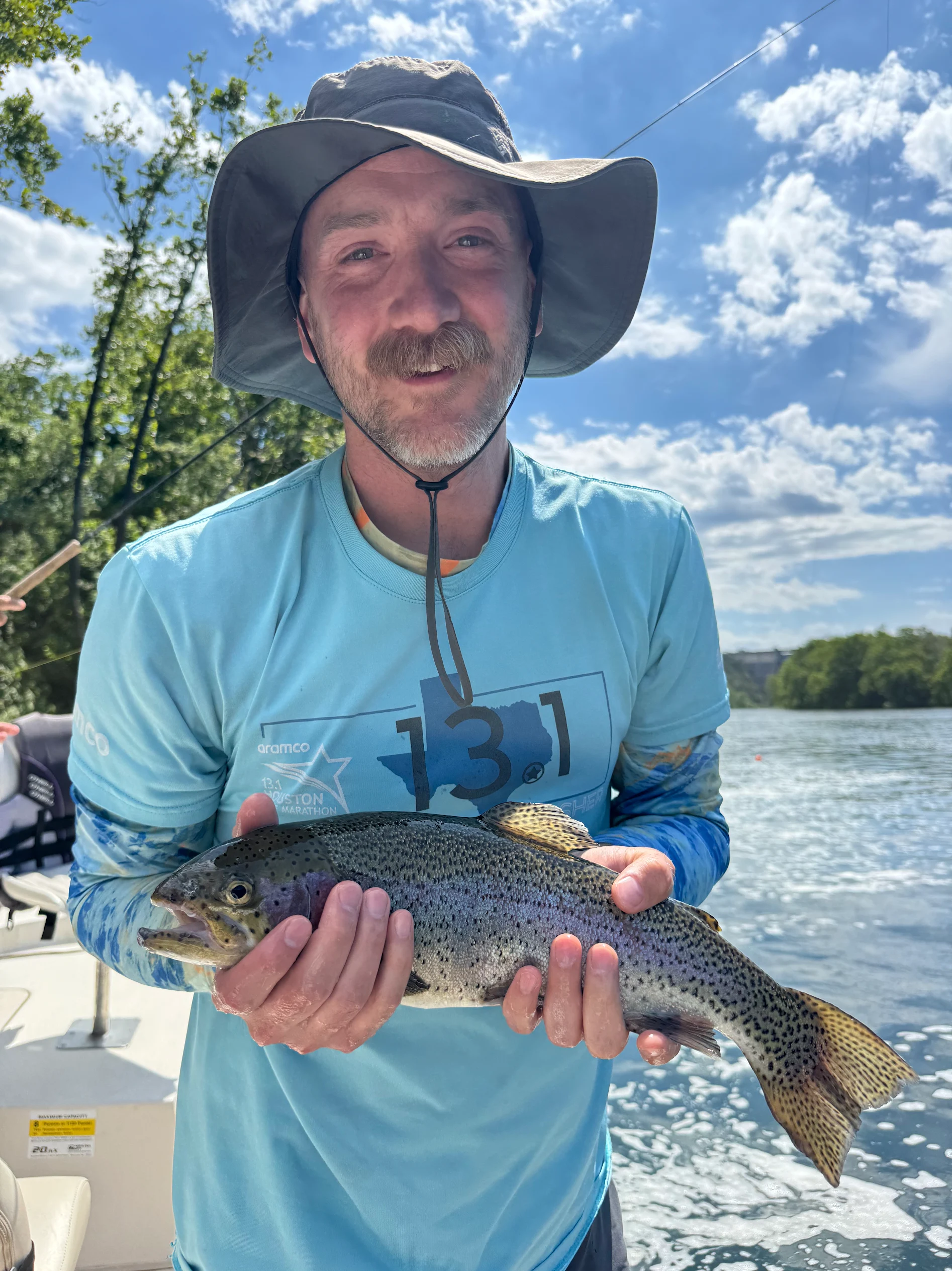 Lake Taneycomo angler holding a rainbow trout