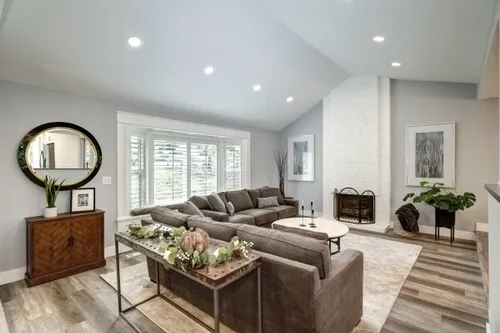 full house remodel living room dining room white fireplace painted brick