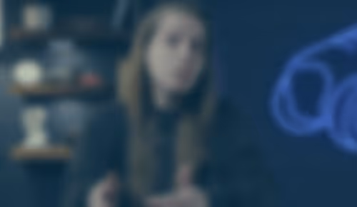 Person sitting in dimly lit room with blurred background