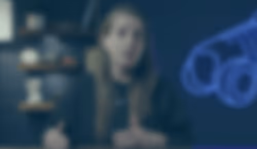 Blurred person sitting in dimly lit room with scientific or medical equipment