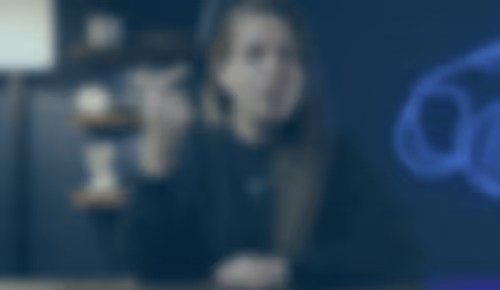 Person sitting in dimly lit room with blurred background