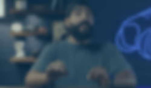 Person sitting in dimly lit room with blurred background