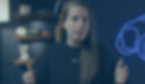 Blurred figure in dark clothing standing in dimly lit interior space