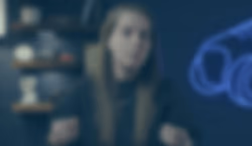 Blurred portrait of a person in a dimly lit, moody setting