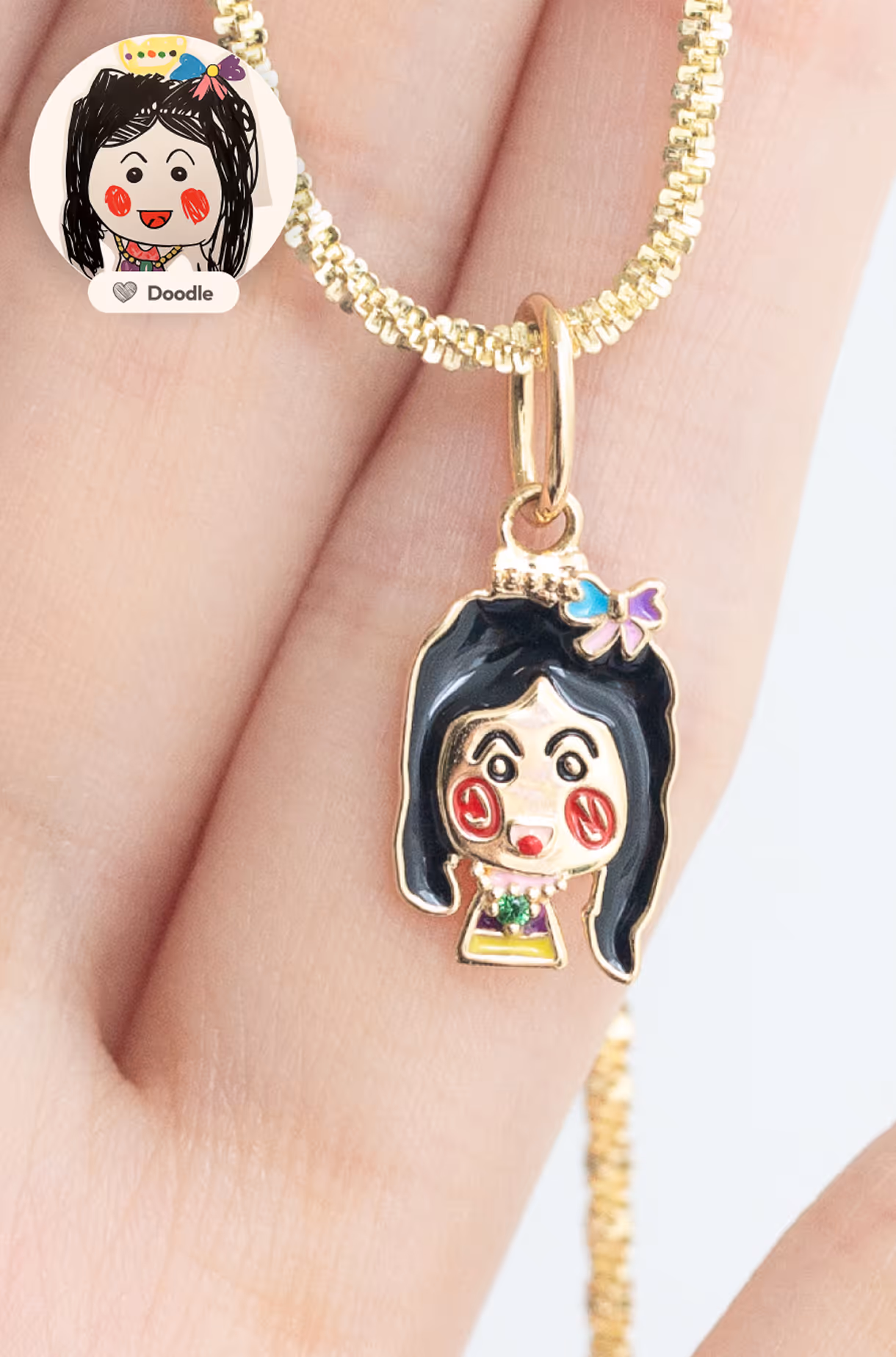 Custom gold necklace featuring a child’s drawing transformed into a colorful 2D enamel pendant of a girl’s face.