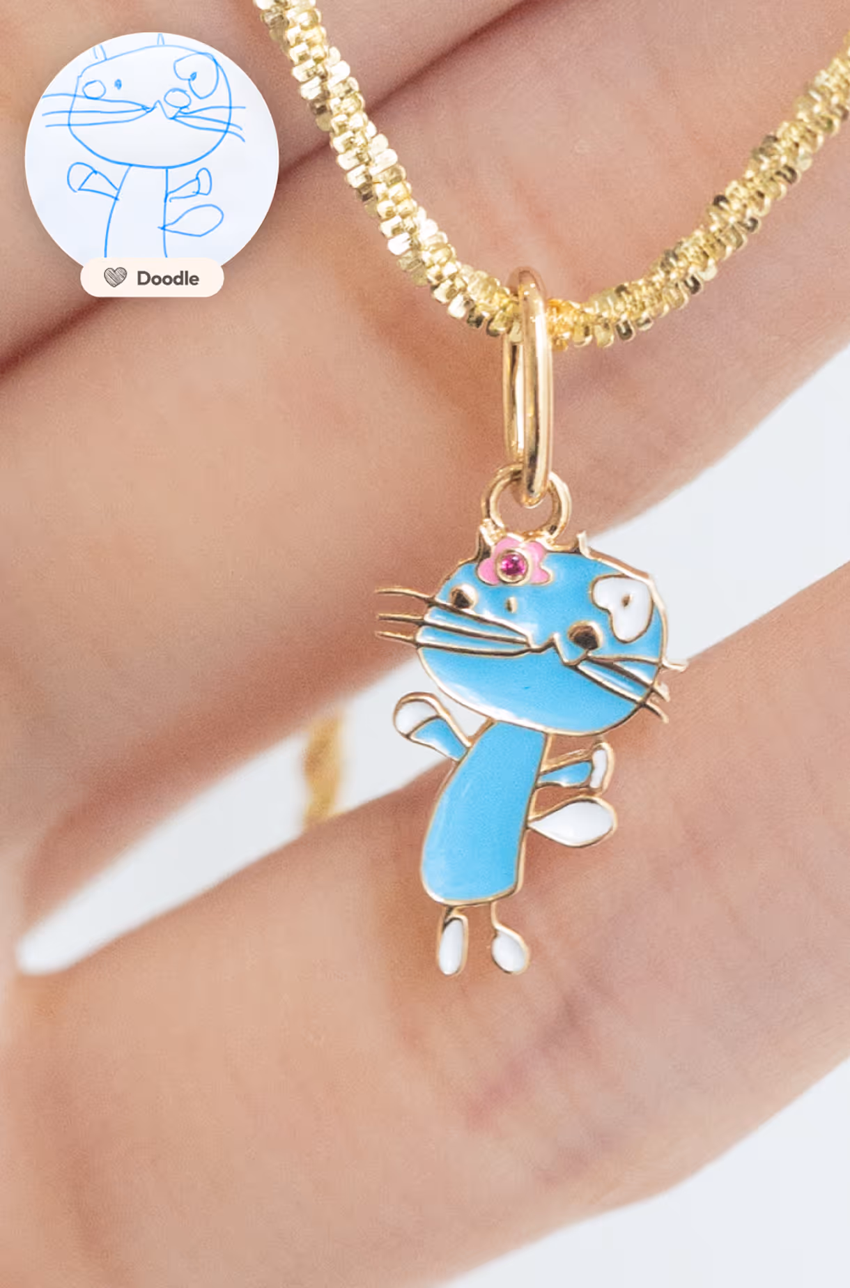 Personalized gold necklace with a pendant based on a child’s drawing of a playful blue cat.