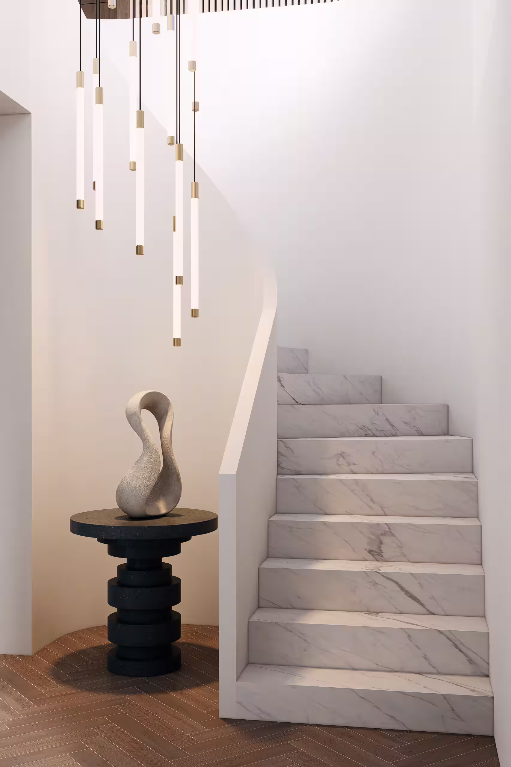 Modern white marble staircase with a black round table holding an abstract sculpture, and hanging pendant lights above.