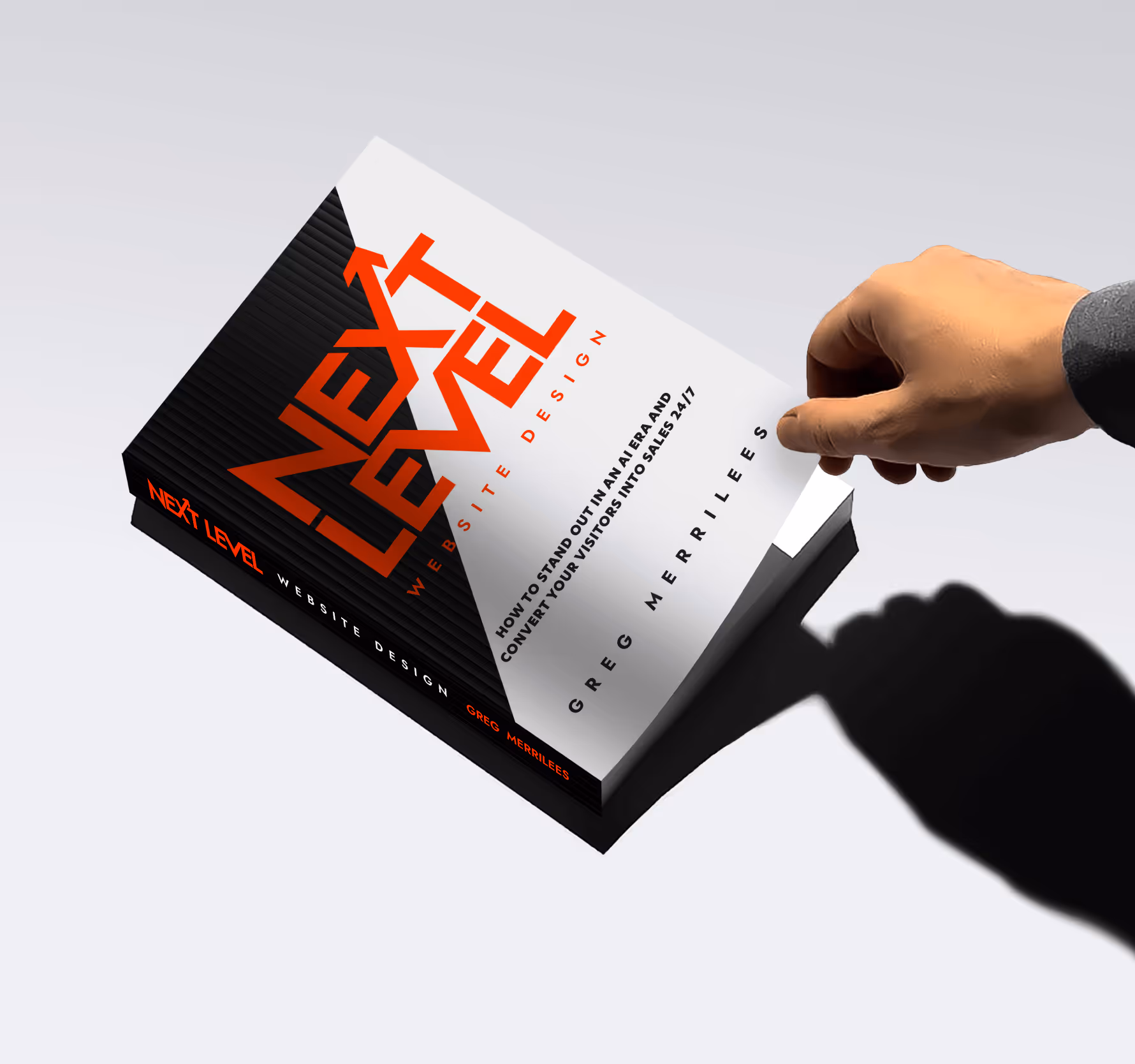 Hand lifting the cover of a book titled 'Next Level Website Design' by Greg Merrilees.