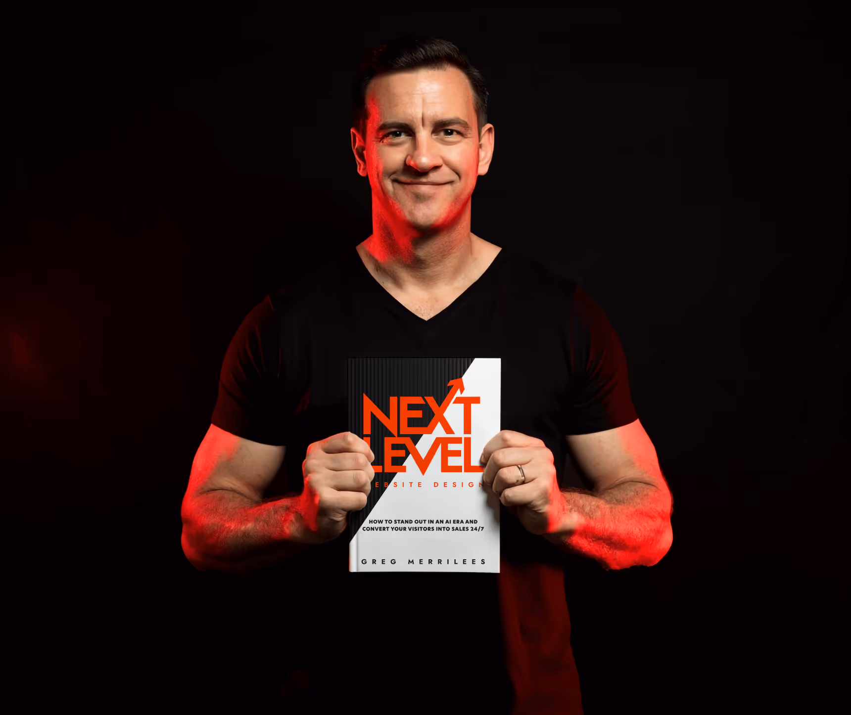 Man wearing black shirt holding a book titled 'Next Level Website Design' by Greg Merrilees.