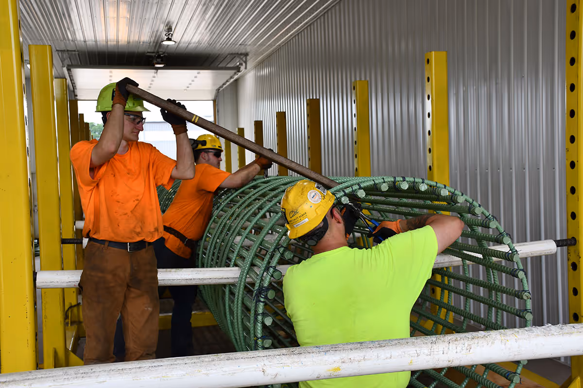 Worker in Brayman Precast facility working on reinforcing bar cage