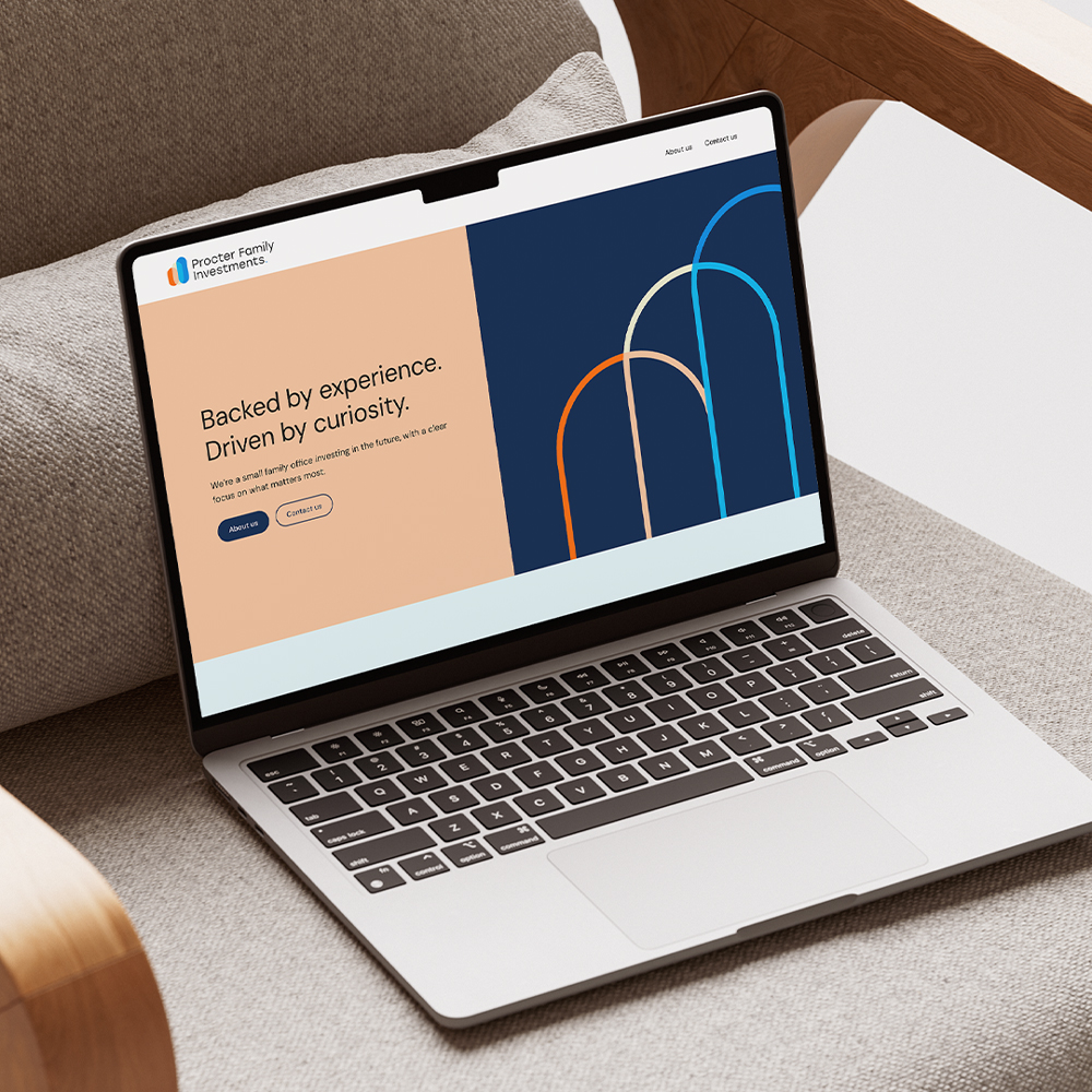 Laptop on a chair displaying Procter Family Investments website