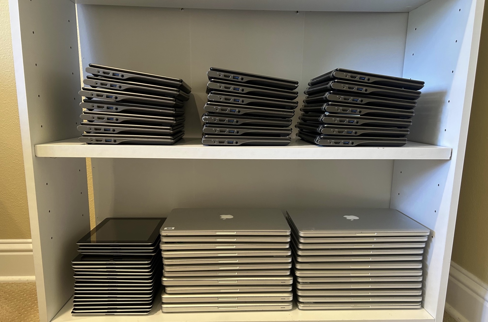 Various macbooks, chromebooks, and ipads used for donations.