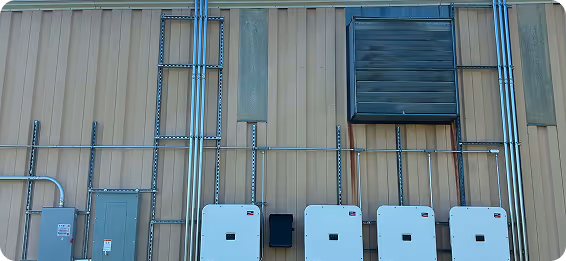 A row of power boxes are mounted on a wall.