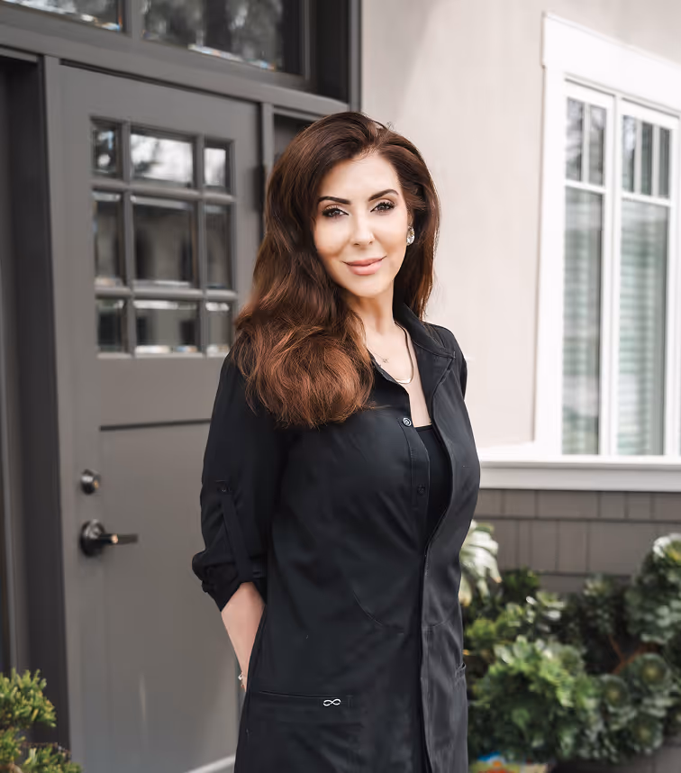 Friendly, professional looking woman standing in front of a door