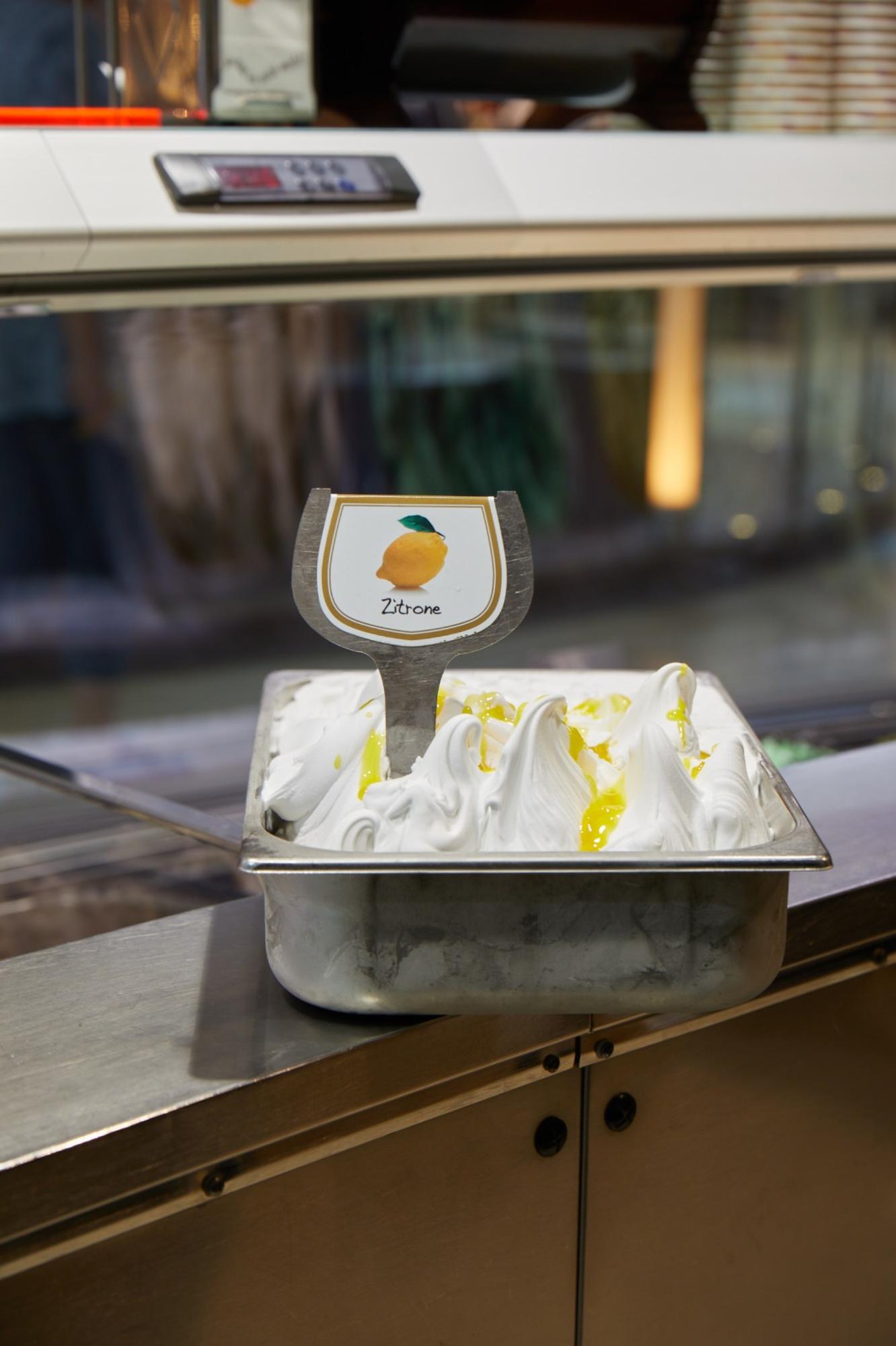 Zitroneneis in der Verkaufsvitrine vom Eiscafé Rimini, frisch servierbereit.