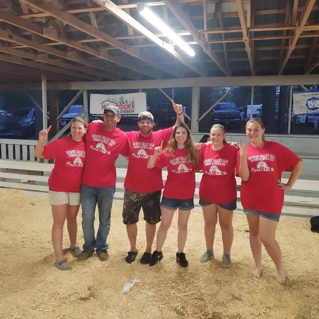 A group of people in red t-shirts posing for a picture.
