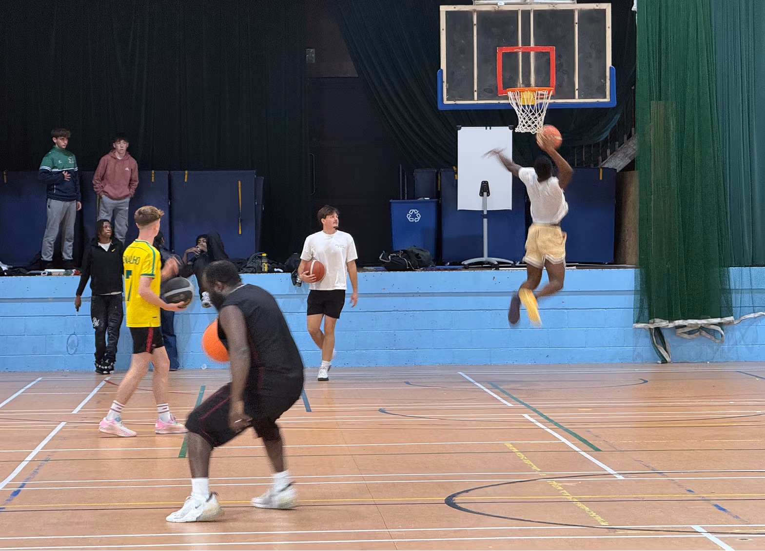 Students practicing basketball at the sports arena in TUS