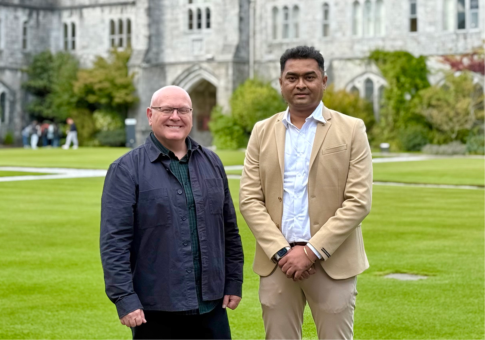 From left to right - Michael O’Sullivan and Amar in front of the iconic building at the University College Cork campus