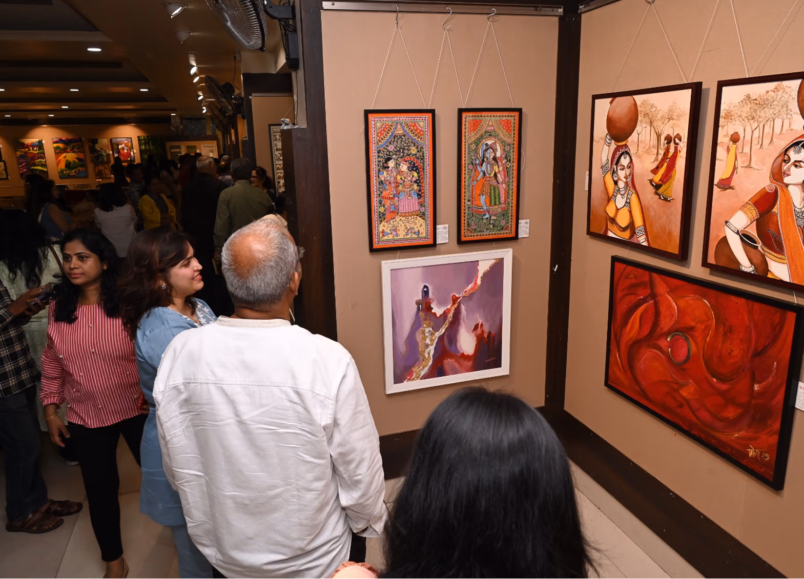 Aadi shows her artworks displayed at the PAF event to Mr. Dilip Kadam.