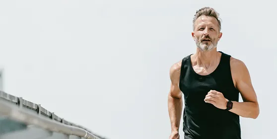 Man jogging outdoors, representing the energy, stamina, and overall vitality benefits of optimized testosterone health through Gameday Men’s Health.