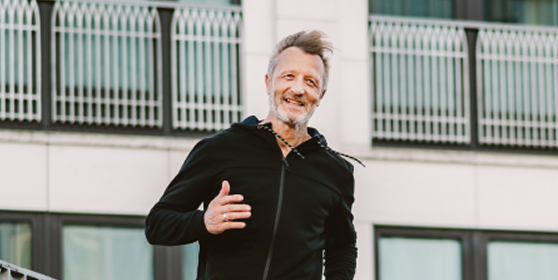 Man jogging outdoors, representing the energy, stamina, and overall vitality benefits of optimized testosterone health through Gameday Men’s Health.