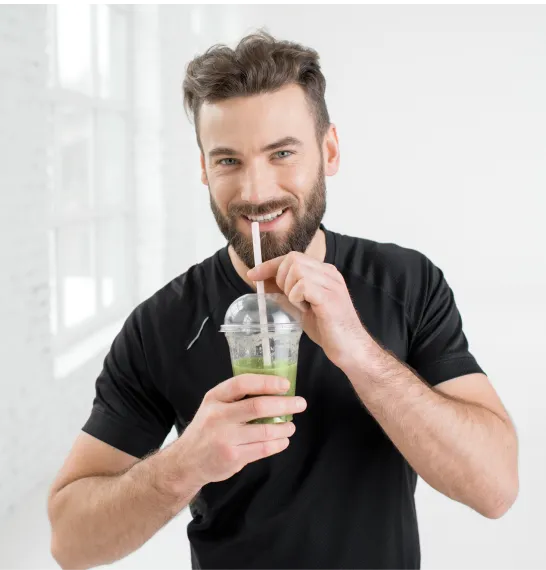 Man enjoying a green smoothie, supporting his weight loss journey with the help of Phentermine medication