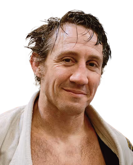 UFC fighter Tim Kennedy posing shirtless with flexed arms at a weigh-in event, featured as a Gameday Men's Health influencer.