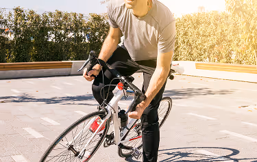male cyclist riding bicycle outdoors