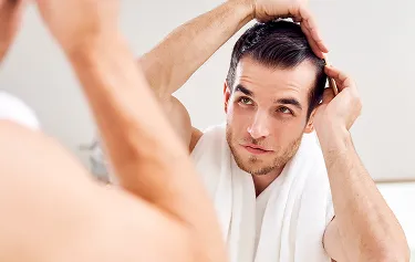 Close-up of PRP hair restoration treatment, showing a medical professional injecting the scalp to stimulate hair regrowth.