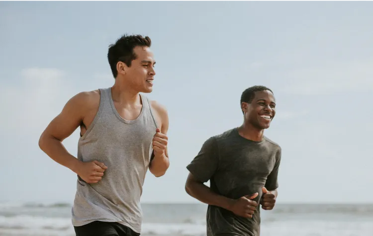 Two men jogging outdoors and smiling, representing increased energy and active lifestyle supported by MIC lipotropic injections. 