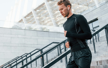 Man jogging outdoors in athletic gear, promoting energy and endurance benefits of Sermorelin peptide therapy