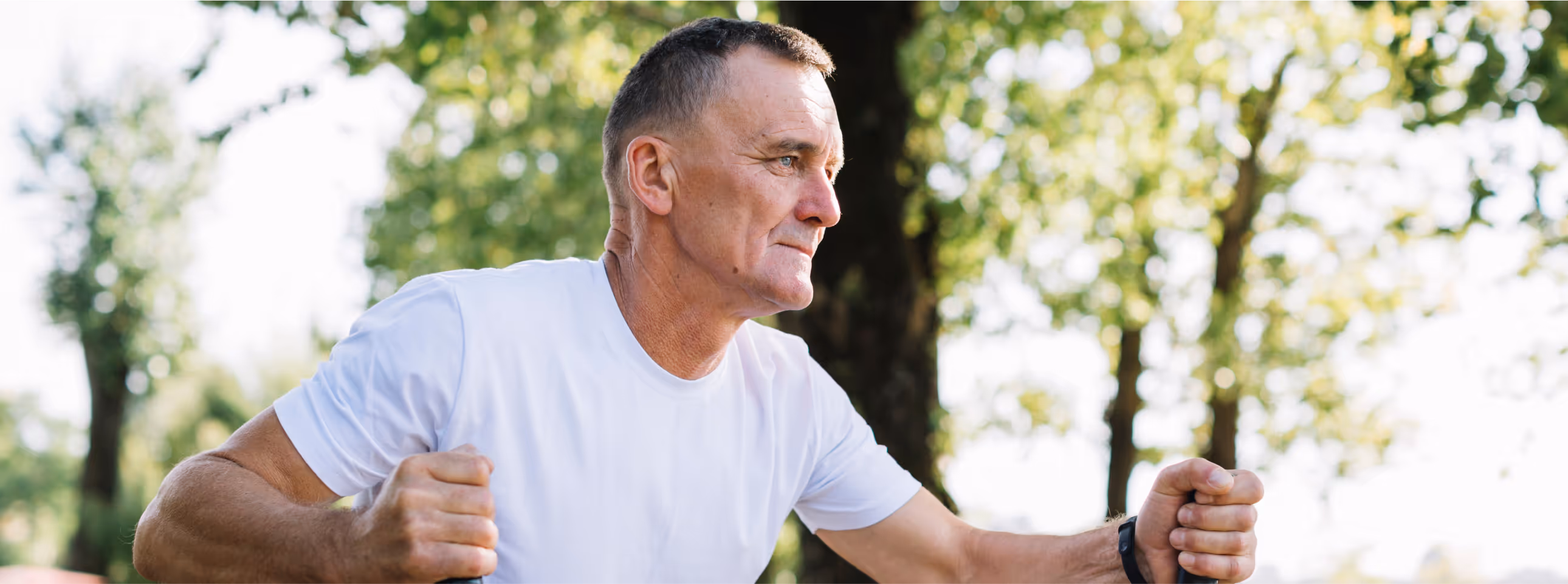Older man using outdoor exercise equipment, highlighting the endurance, cardiovascular, and nervous system support offered by Vitamin B Complex injections.