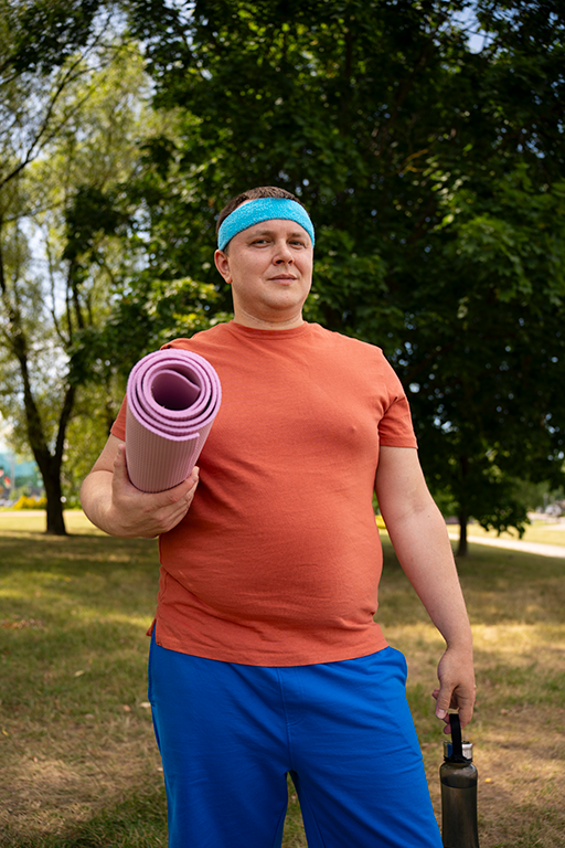 Man with a yoga mat, embracing a healthier lifestyle with the support of GLP-1 medications for weight management