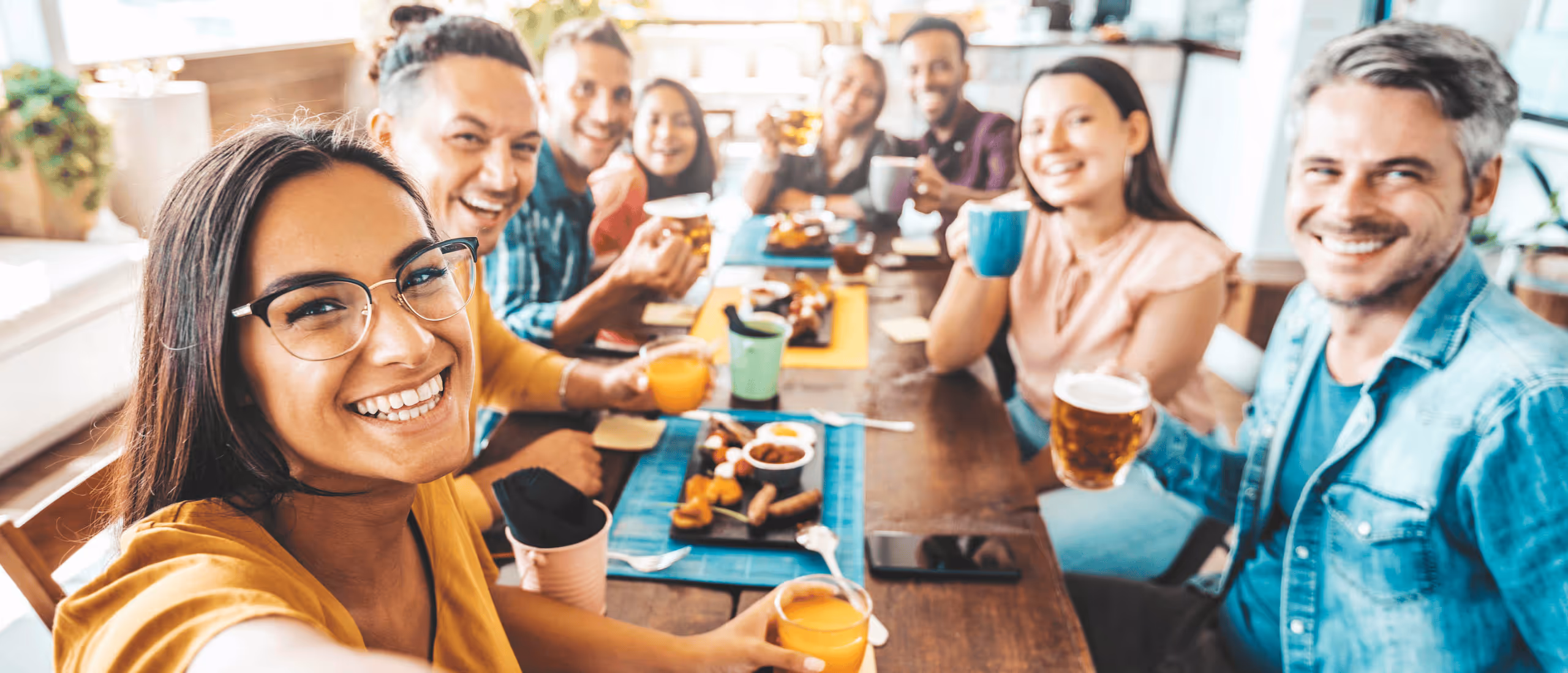 A group selfie of several people at a table eating brunch