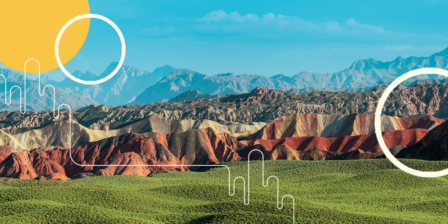 Layered materials of mountains, rocks, grass and sky.