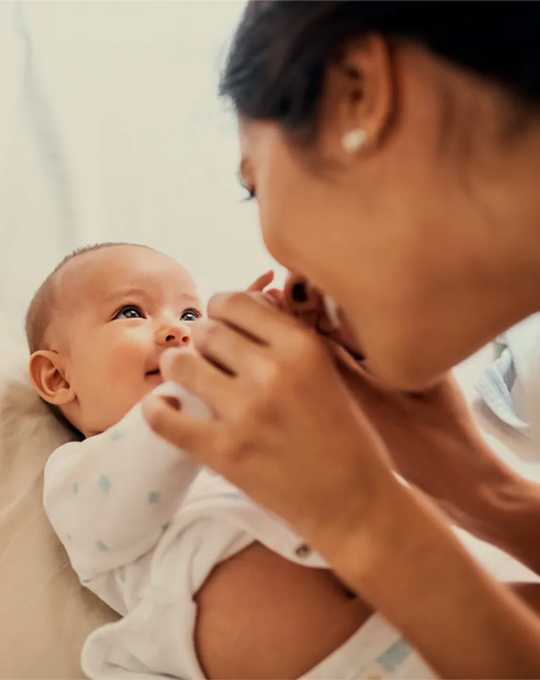 A woman holding a baby in her arms.