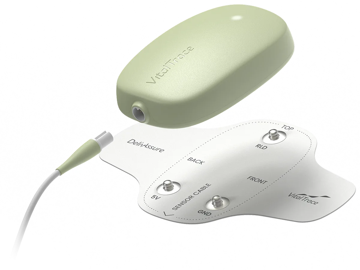 A green and white device is connected to a charger.