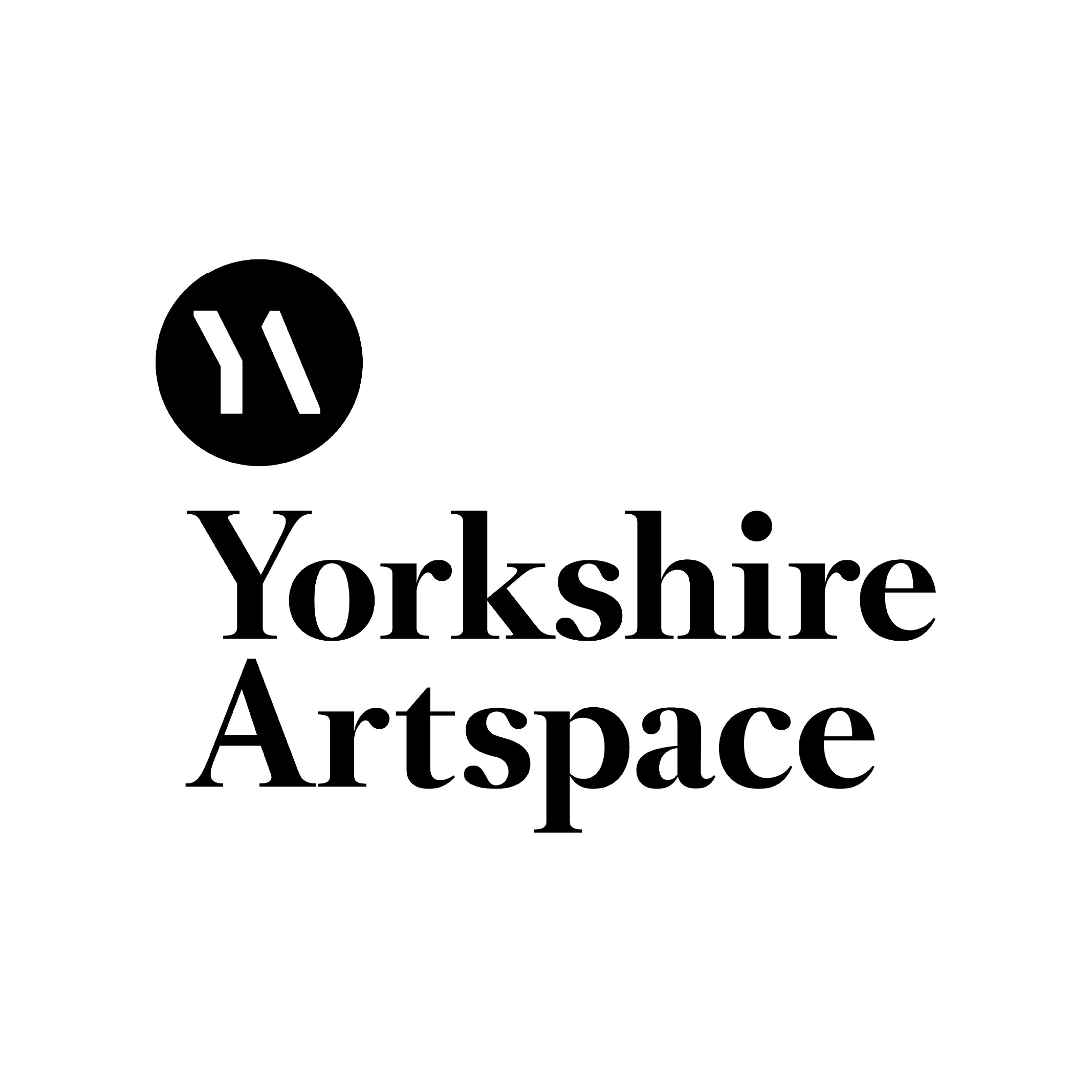 Jodie Cooper Jodie smiling sitting beside her sewing machine in her workspace.