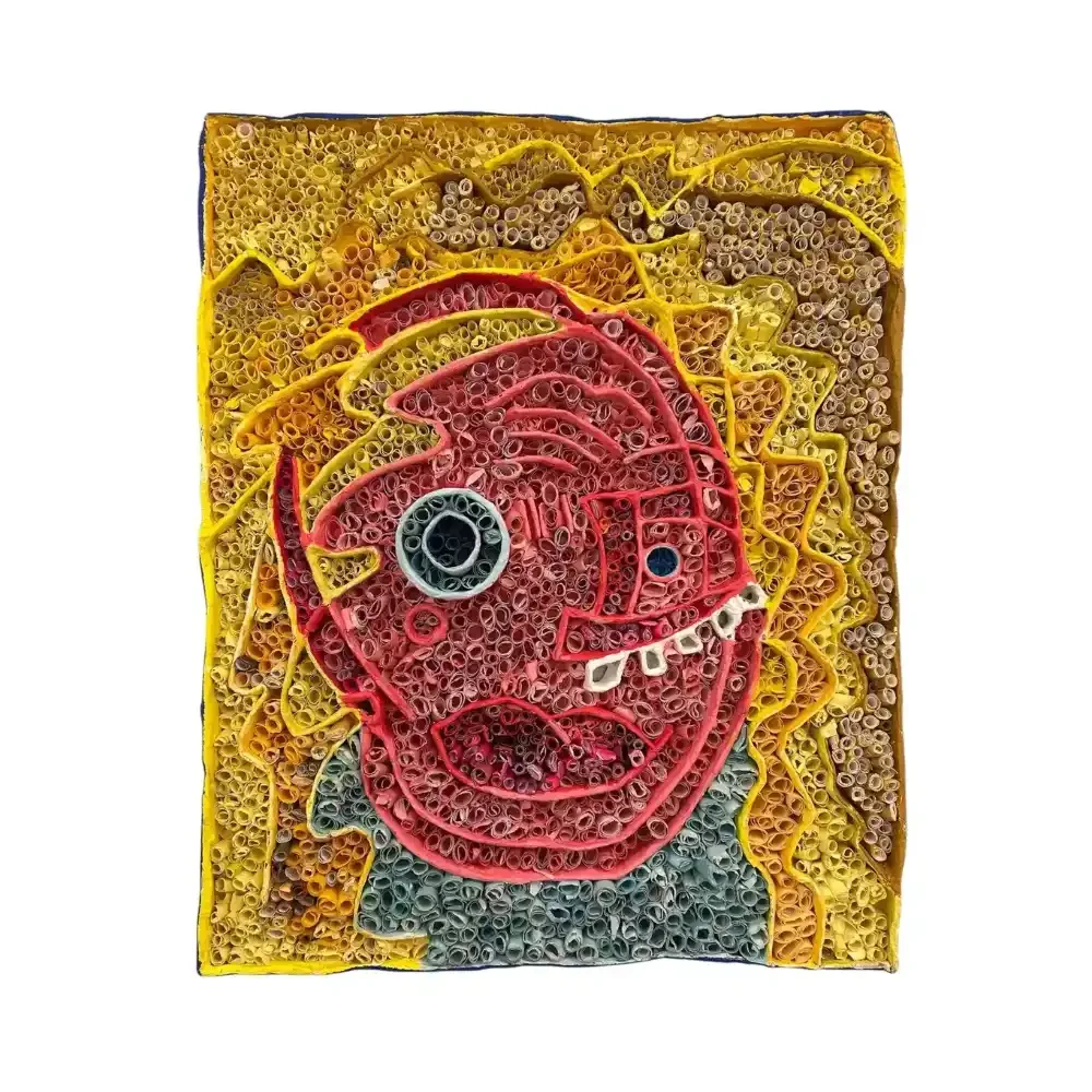 "Debs with the Yellow Hair," a tactile self-portrait created using paper quilling. The composition features rows of tightly rolled "paper quill soldiers" arranged in structural channels to form a face. The piece uses vibrant yellow for the hair and blue for the eyes, combining memory, touch, and repetitive craft to bridge the gap between visual and tactile art.