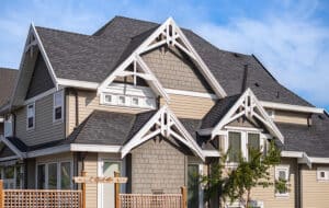 Houses with shingle roof against blue sky. 