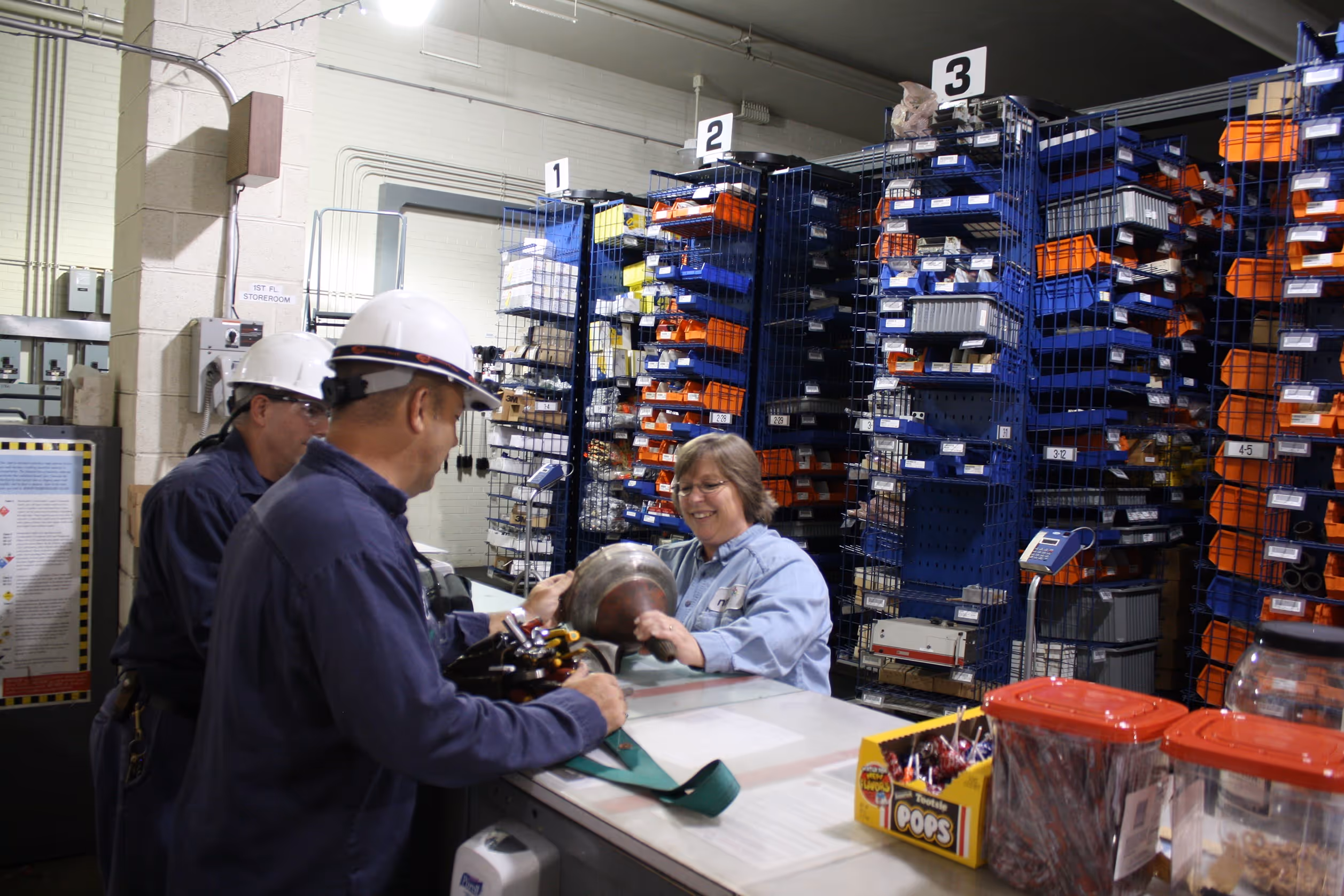Electrical workers at storage/checkout counter