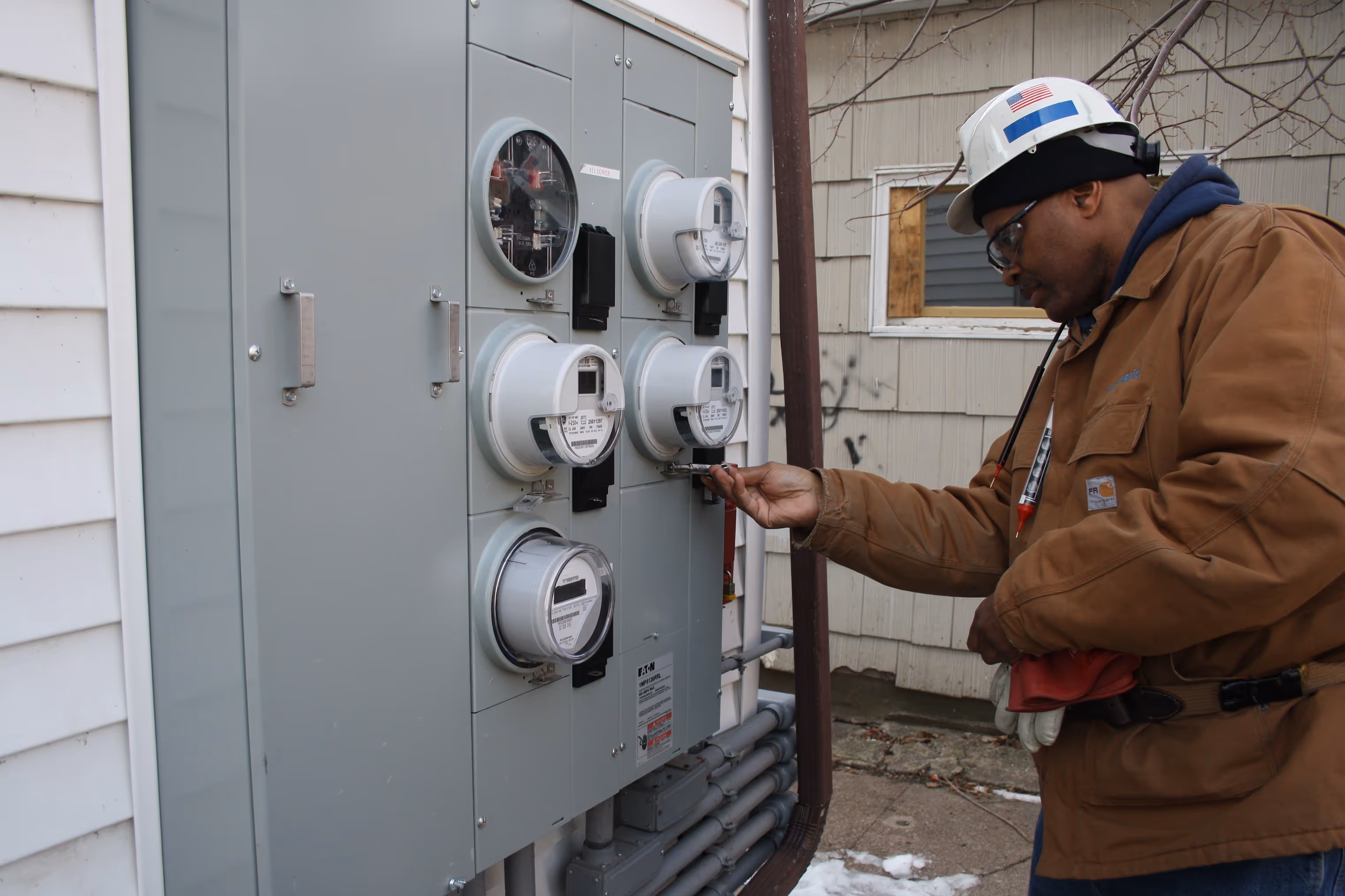 Electrical worker focused on a panel