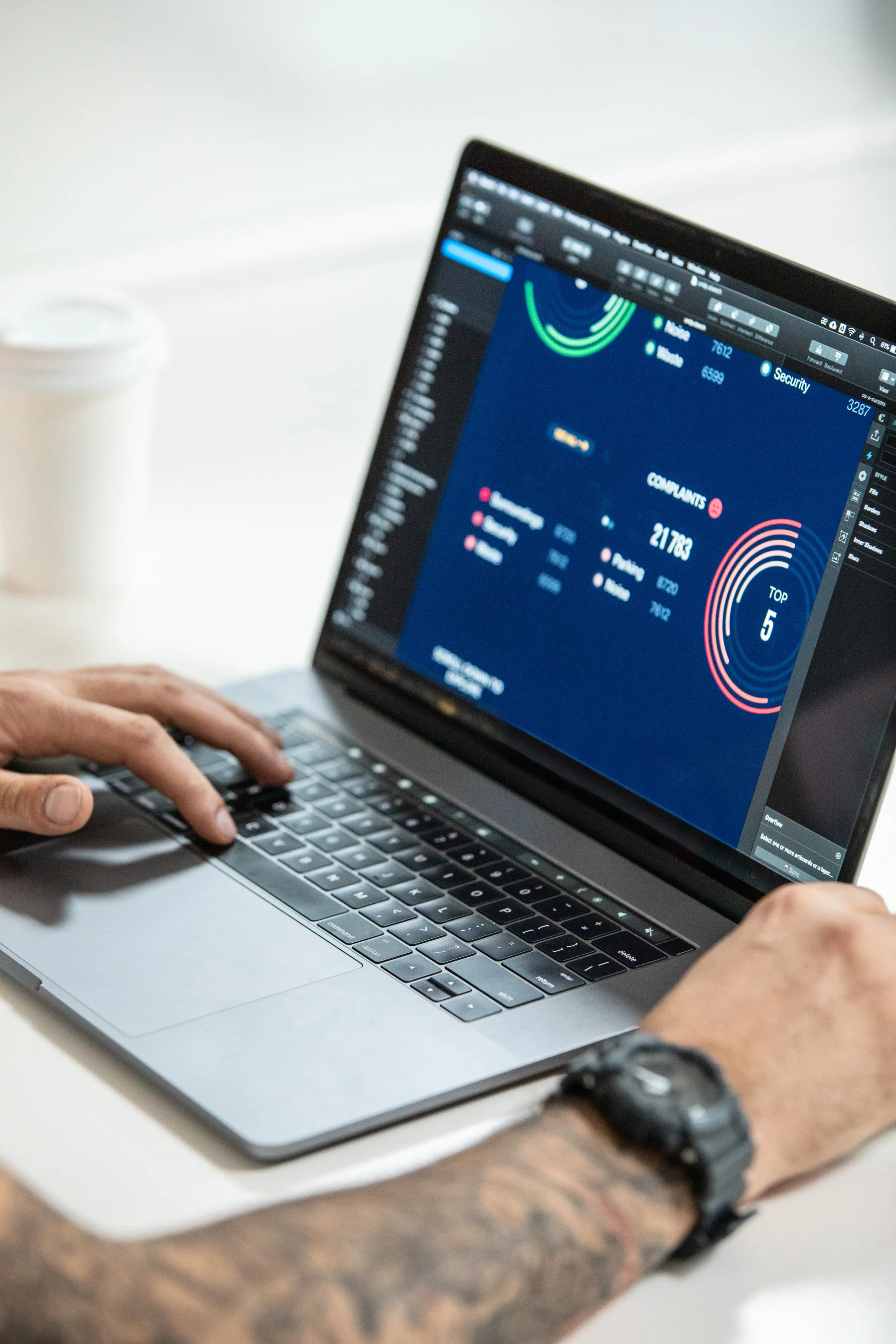 person analyzing data dashboard on laptop with dark UI
