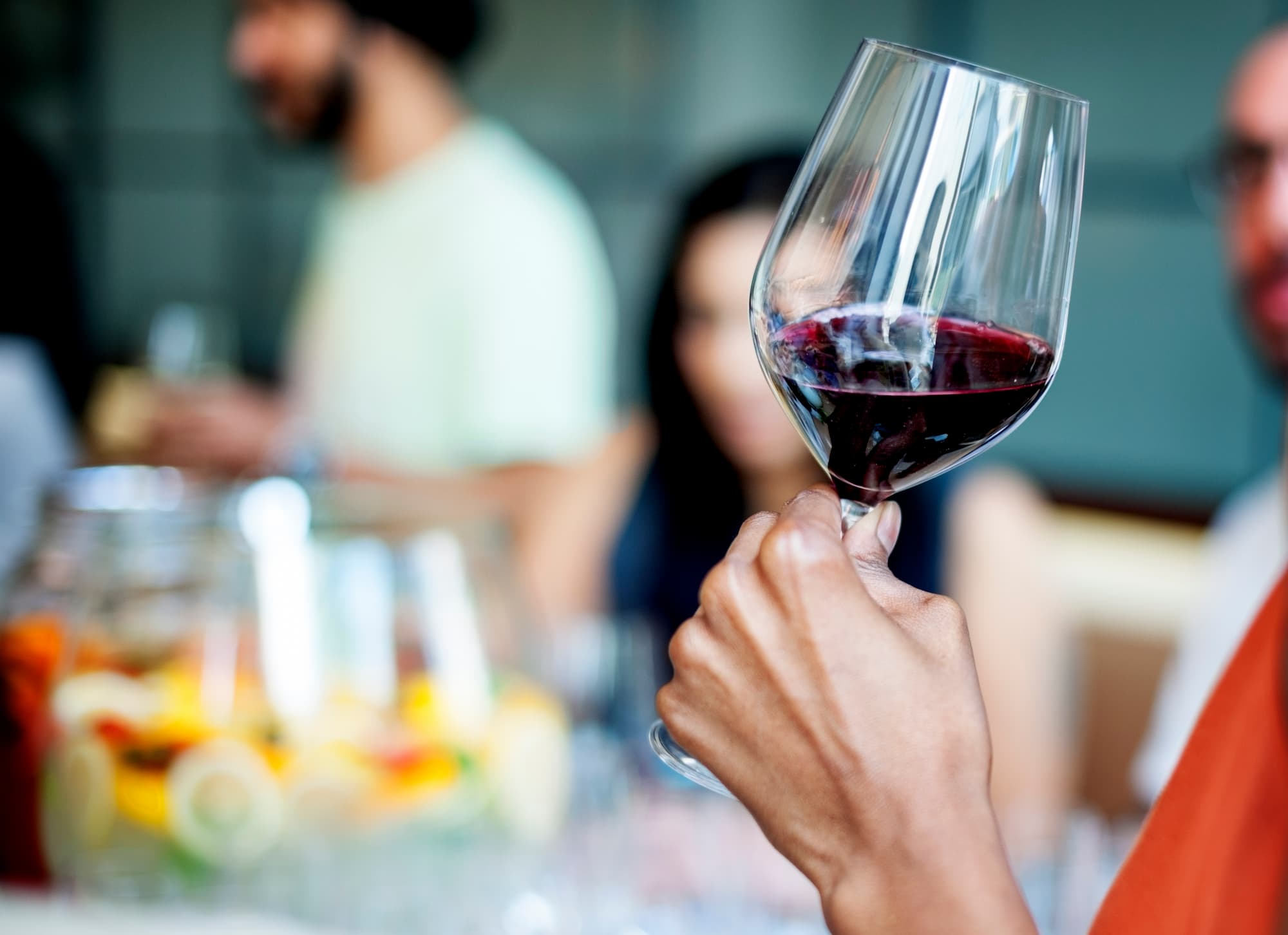 woman holding glass of wine close up
