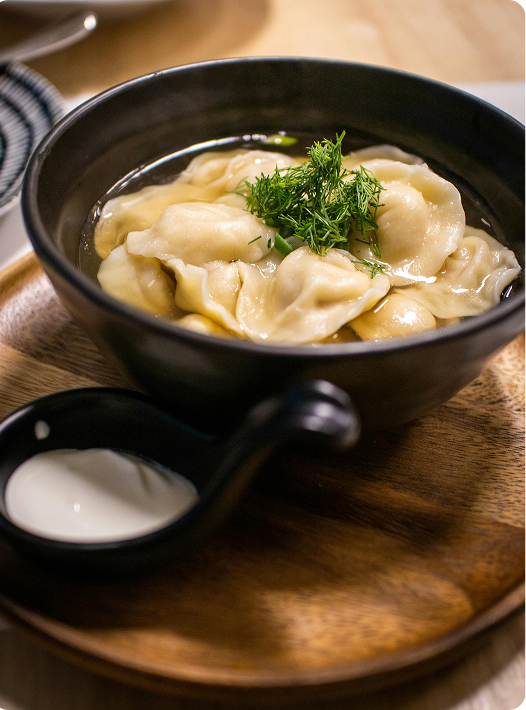 A picture of a delicious bowl of dumplings.