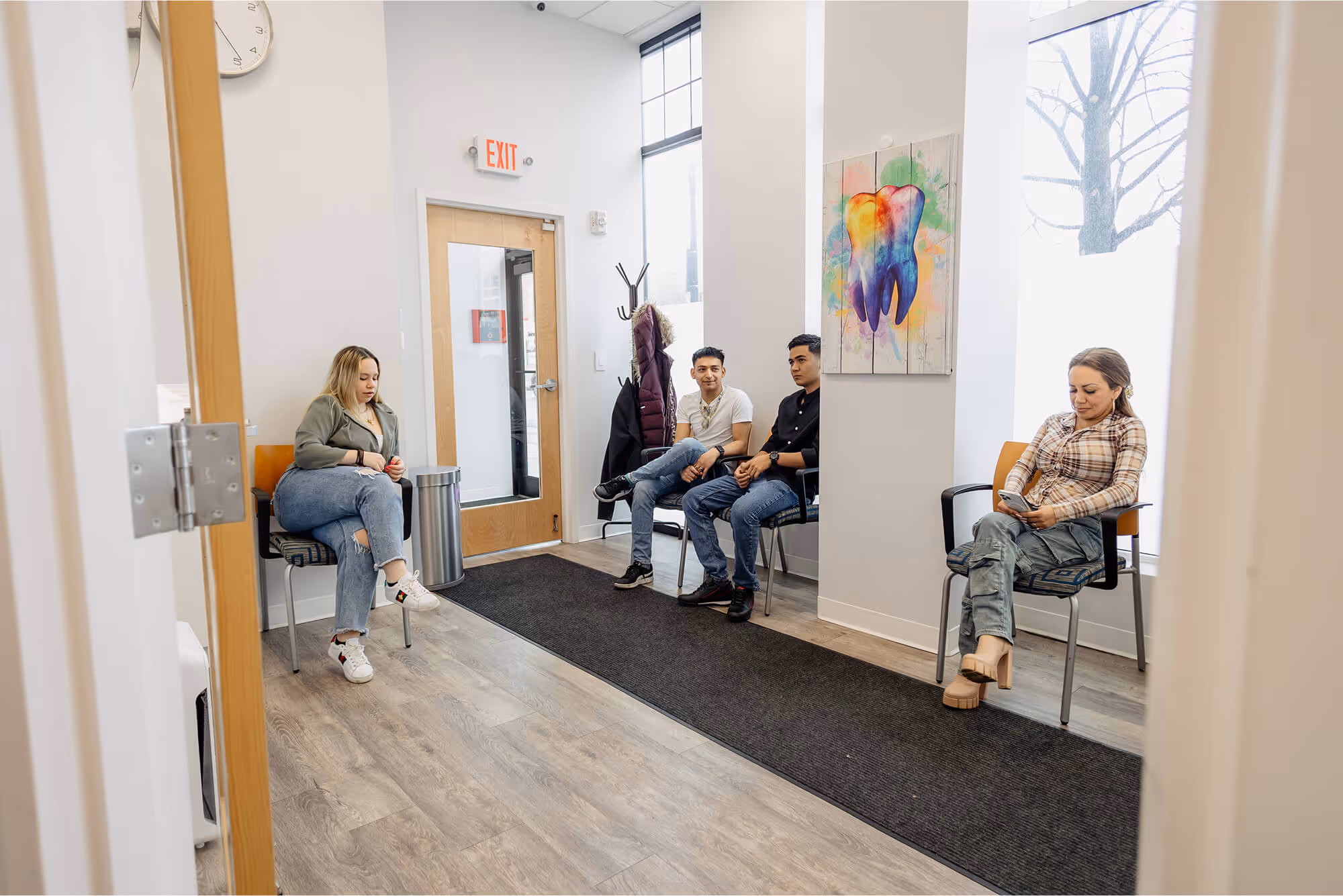 A group of people sitting in chairs in a room.