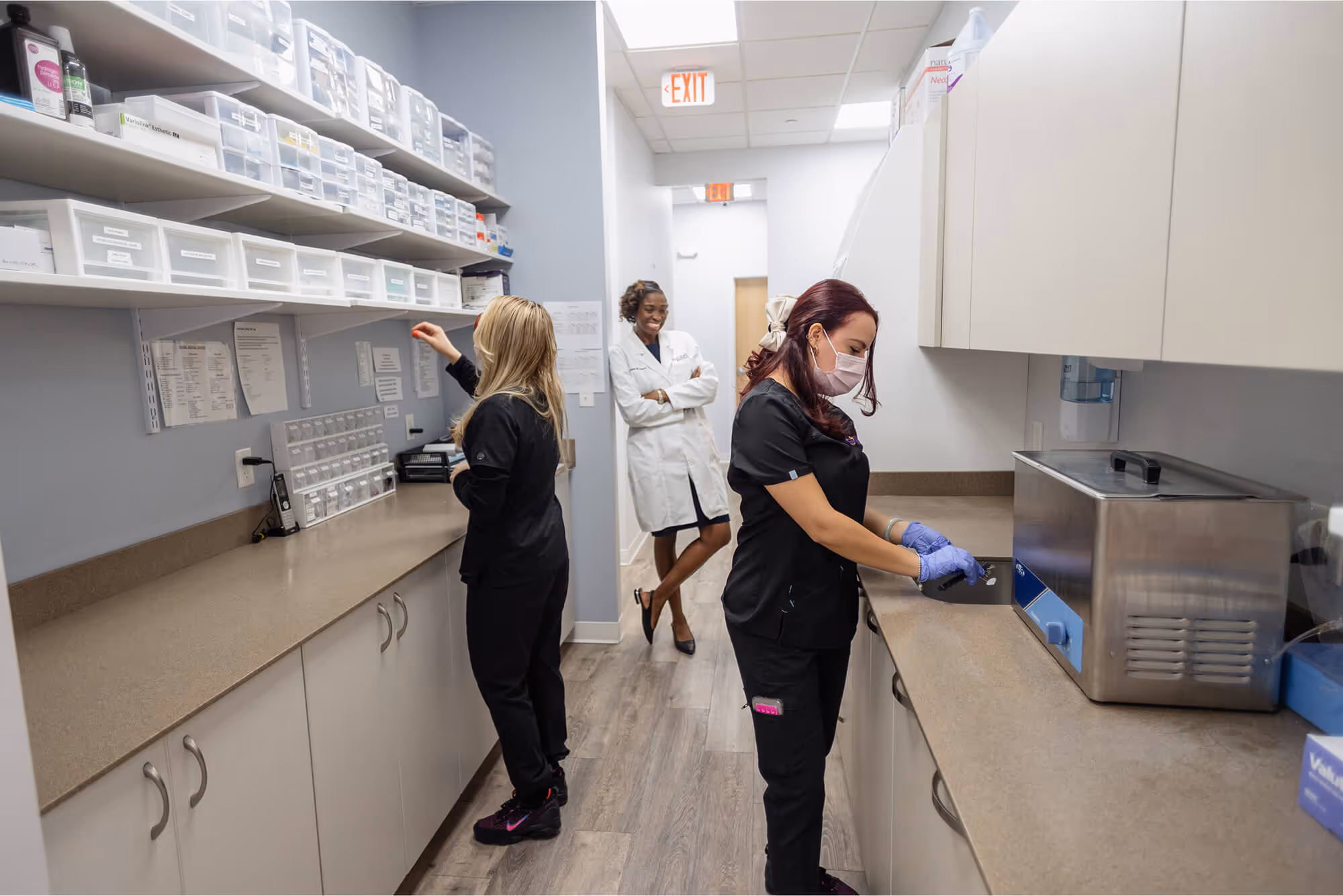 A group of women in scrubs in a lab.