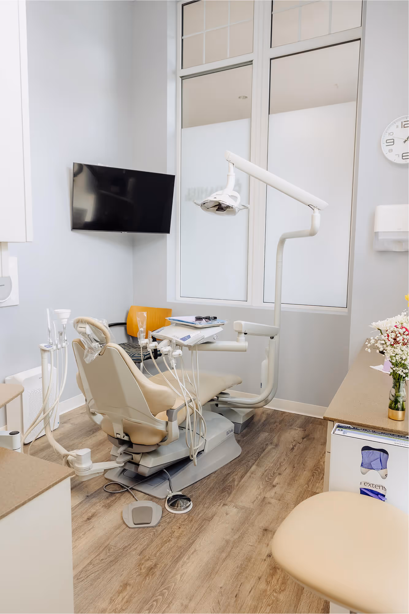 A dental room with a chair and a monitor.